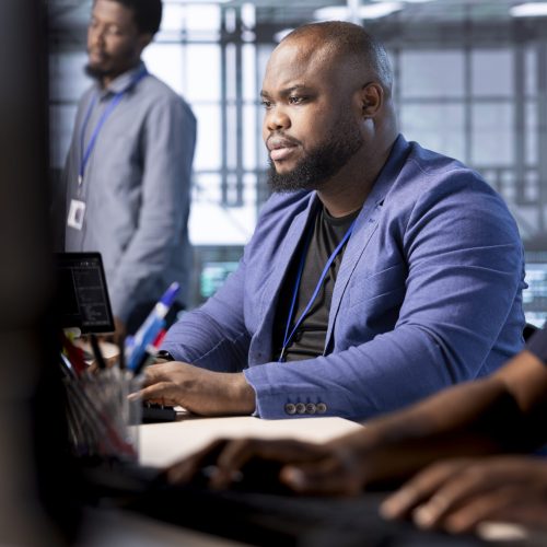 System administrator in data center protecting company critical infrastructure Cybersecurity technician monitoring security incidents affecting server hub workspace. System administrator in data center protecting company critical infrastructure from cyber threats
